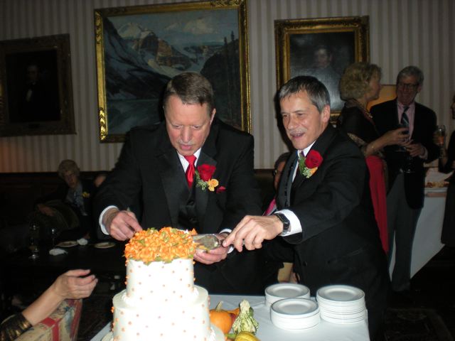 the two grooms cut the cake